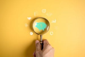 magnifier focus to piggy bank icon for saving education, study learning for future, education course degree, study knowledge to creative thinking idea and problem solving solution