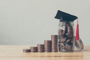 scholarship money concept. coins in jar with money stack step growing growth saving money investment